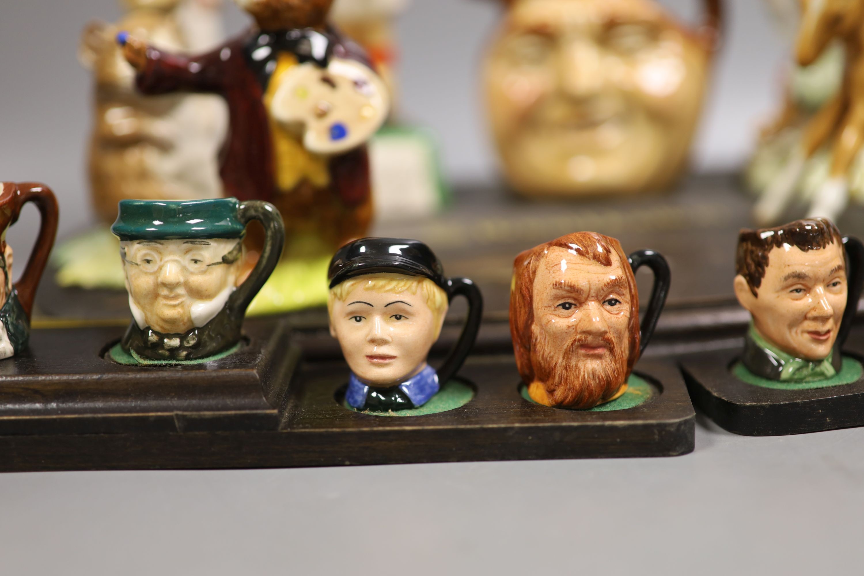 A collection of Royal Doulton miniature character mugs, figurines, series plate etc